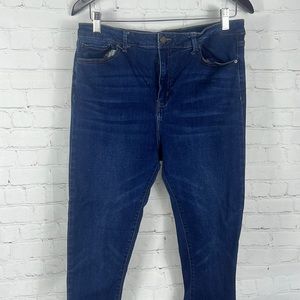 Lightly worn dark blue jeans. Skinny